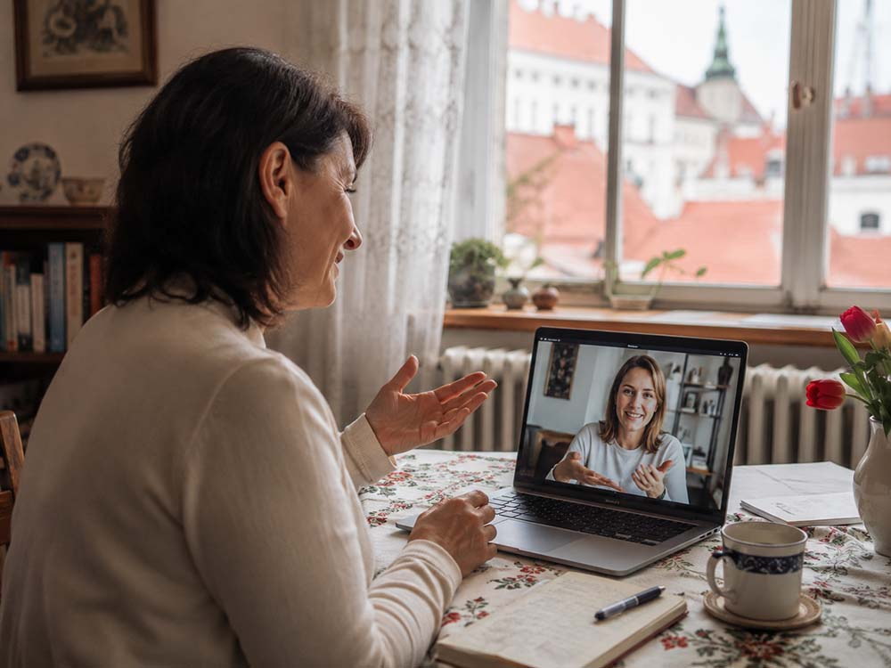 Frau übt Ungarisch im Video-Unterricht am Laptop zu Hause